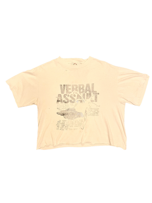 Beige t-shirt with 'Verbal Assault' graphic design on a white background