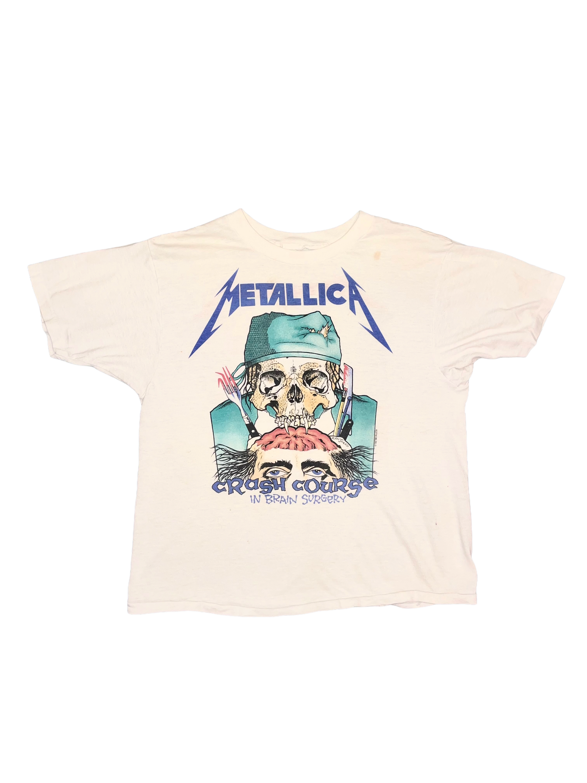Beige t-shirt with Metallica graphic design by Pushead on a white background
