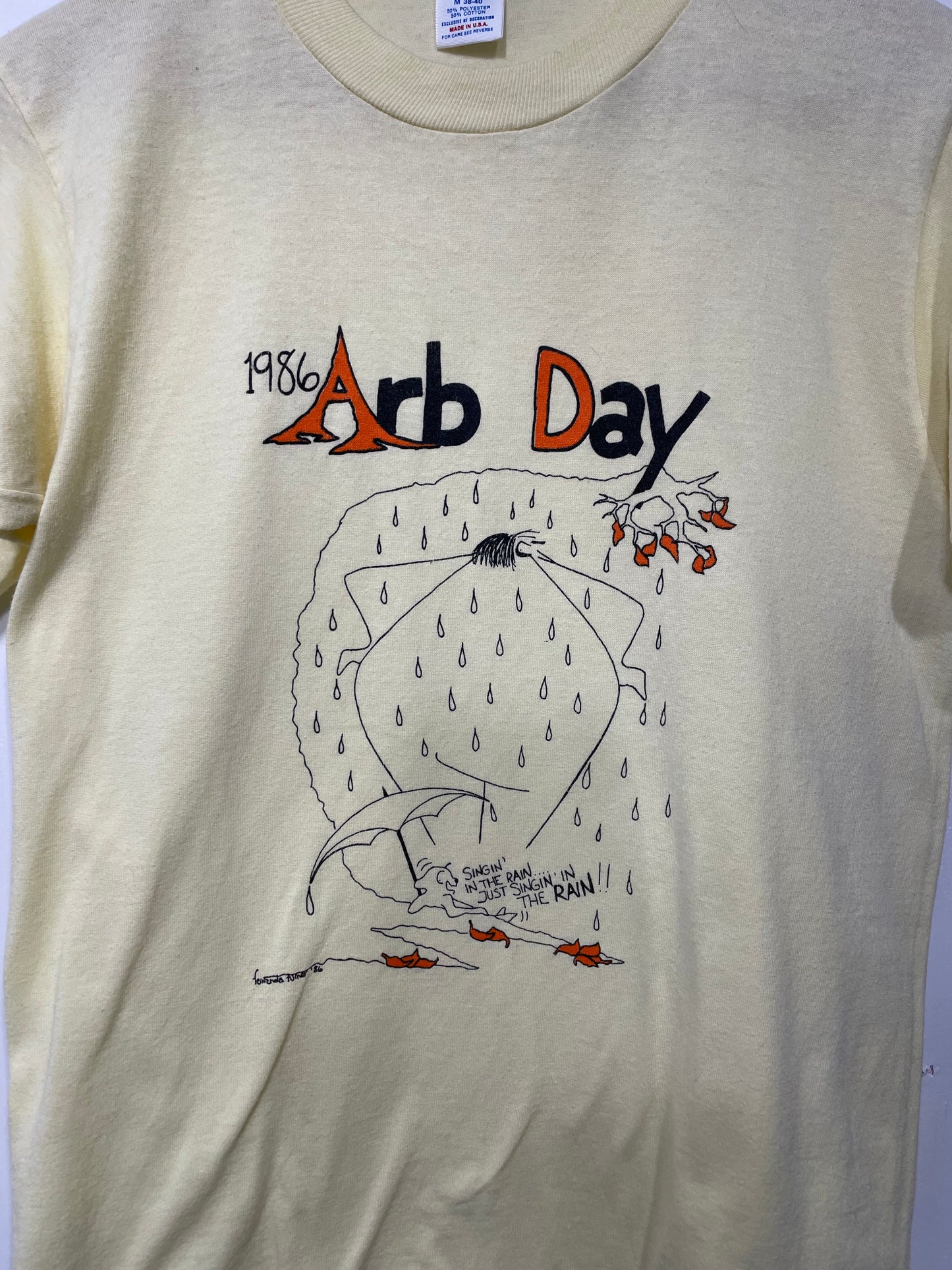 1986 Pale Yellow Arb Day Rain Graphic Tee